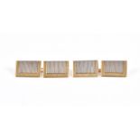 A pair of 18ct yellow gold cuff links with rectangular faces and engine-turned decoration.