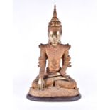 A large 19th century Burmese gilt bronze Buddha his hands in bhumisparsha mudra, wearing a serene