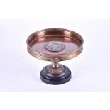 A Victorian bronze tazza decorated with a moulded head of a classical woman, the rim decorated