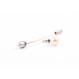 A yellow metal and grey pearl stick pin (laboratory analysis concluded natural saltwater pearl,