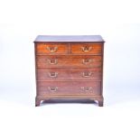 A 19th century oak chest with two short over three graduated drawers, brass handles, on bracket