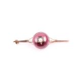 A late 19th / early 20th century 9ct yellow gold and garnet brooch set with a red cabochon garnet,