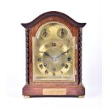An early 20th century oak cased mantel clock by Gustav Becker with a chiming movement, the brass