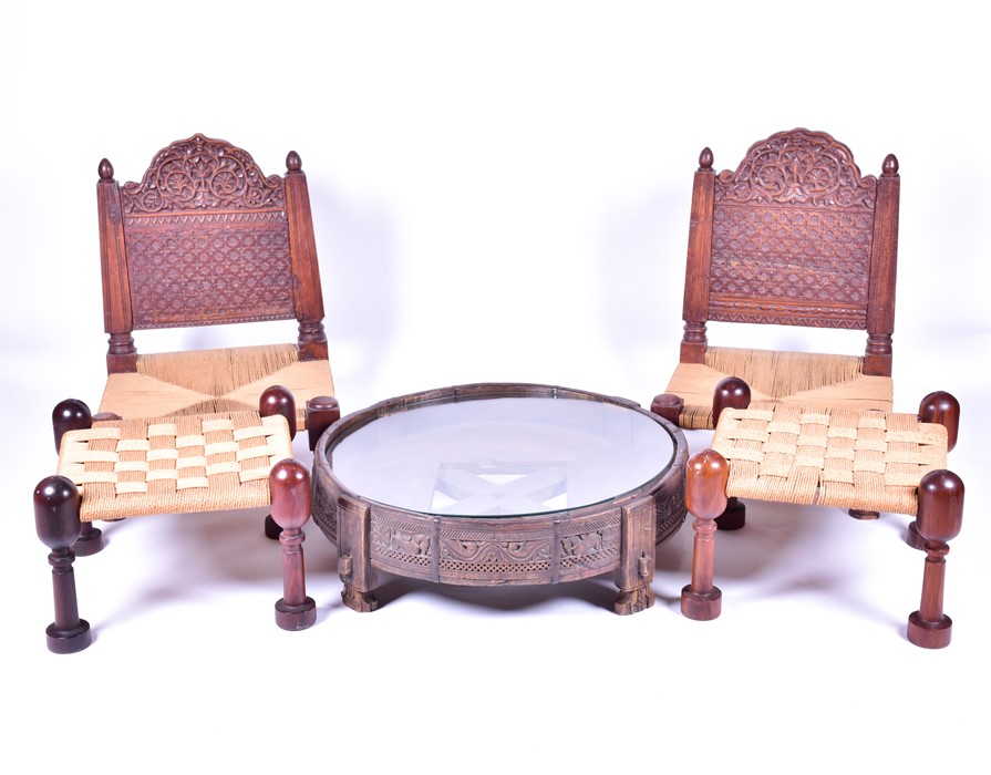 A pair of early 20th century Indian carved hardwood pida chairs, with rush seating, together with