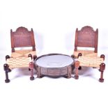 A pair of early 20th century Indian carved hardwood pida chairs, with rush seating, together with