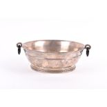 Cartier. A circular silver bowl with twin black onyx loop handles, engraved with initials 'SRMB',