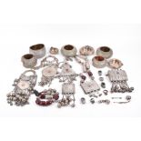 An unusual group of white metal items including various bangles converted into pots and bowls, a