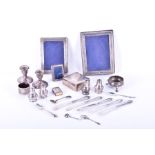 A mixed collection of silver items to include photograph frames, cruets, a small cigarette box,