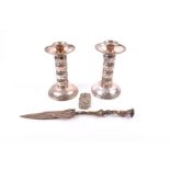 A pair of silver plated column candlesticks with beaded decoration, 17 cm high, together with a