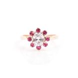 A 14ct yellow gold, diamond and ruby cluster ring set with an oval cushion-cut diamond of