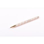 Van Cleef and Arpels. An 18ct rose and yellow gold and silver ball point pen with twisted design,