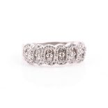 A white gold and diamond ring the swirled mount inset with small round-cut diamonds of approximately