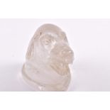 A 20th century carved rock crystal dog's head with bared teeth, approximately 8 cm high.