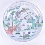 A large Kangxi Famille verte porcelain charger  designed with polychrome enamels depicting a