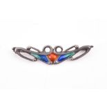 A Cymric silver and enamel brooch for Liberty & Co by Archibald Knox decorated in orange, blue,