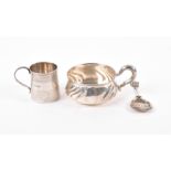 A George III silver Christening mug together with a white metal porringer with swept decoration to