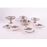 Four early 20th century English silver footed dishes all with various design, including pierced