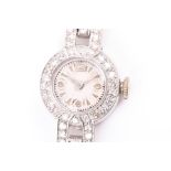 An Art Deco diamond ladies cocktail watch the round cream dial with batons and Arabic numerals,