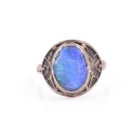 A silver and opal ring in the Arts and Crafts taste, set with a blue and green oval-shaped opal, the