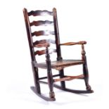 A childs 18th century oak ladder back rocking chair with shaped back bars, turned arms and legs, and