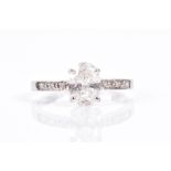 An 18ct white gold and diamond ring set with a mixed oval-cut diamond of approximately 1.10