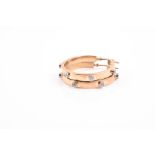 A pair of 9ct yellow gold and diamond hoop earrings each hoop set with five bezel-set diamonds,