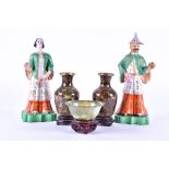 A pair of early 20th century porcelain figures of an Oriental couple hand painted with gilt