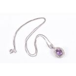 An 18ct white gold, diamond, and amethyst pendant set with a mixed oval-cut amethyst, surrounded