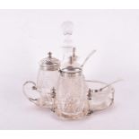 A Victorian silver and cut glass cruet set the quatrefoil stand with London hallmarks for 1879-80,
