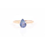 A yellow gold and sapphire ring set with a mixed pear-cut single blue sapphire of approximately 0.95
