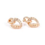 A fine pair of yellow gold and diamond double twist hoop earrings set with round brilliant-cut