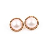 A pair of yellow metal and mabe pearl earrings of rounded form, the pink-ish pearls within a rope-