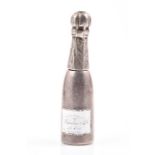 A Victorian white metal propelling pencil by Sampson Mordan & Co modelled as a champagne bottle with