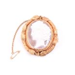 A Victorian yellow gold and cameo brooch set with a turning central segment, decorated to one side