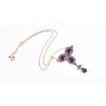 A silver gilt, amethyst, and white topaz drop pendant necklace set with three gemstone clusters