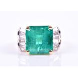 An impressive emerald and diamond cocktail ring set with an octagonal-cut Colombian emerald of