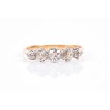 An 18ct yellow gold and old-cut diamond ring set with five graduated old mine-cut diamonds of