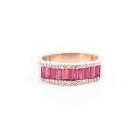 A yellow metal, diamond, and ruby half eternity ring the band channel-set with baguette-cut
