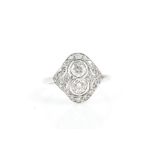 An 18ct white gold and diamond ring in the Art Deco taste, the openwork mount set with two collet