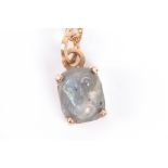 A Victorian carved labradorite monkey's head set in a later yellow gold pendant, approximately 1