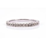 A diamond full eternity ring set with diamond accents, in unmarked white metal (likely gold), size P