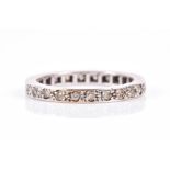 A diamond eternity ring pave set with small diamonds, approximately 0.02 carats each, the white