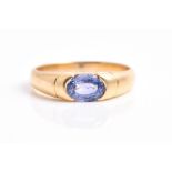 An 18ct yellow gold and tanzanite ring set with a mixed oval-cut tanzanite, stamped 750 to shank,