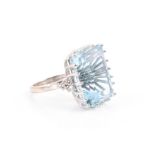 An impressive 18ct white gold and aquamarine cocktail ring set with an octagonal step-cut aquamarine