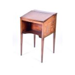 A George III 'Davenport' style writing desk of small proportions the sloping lid enclosing a bank of