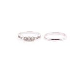 A diamond engagement ring set with three larger graduated stones and smaller stones to the