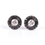 A pair of 18ct black gold, and black and white diamond halo stud earrings each centred with a