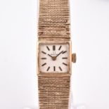 An Omega ladies 9ct yellow gold wristwatch the square silvered dial with baton hour markers, with