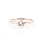 A 14k gold and solitaire diamond ring set with a round-brilliant cut diamond of approximately 0.60
