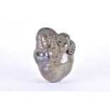 A hardstone Inuit carving of a mother and child  in a tender embrace, with polished rounded body,